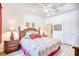 Bright primary bedroom boasts tray ceiling, wood furniture, and a large window dressed with red curtains at 601 Hillside Dr. N # 4133, North Myrtle Beach, SC 29582