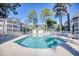 Relaxing community pool surrounded by lounge chairs and tall trees at 601 Hillside Dr. N # 4133, North Myrtle Beach, SC 29582