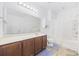 Bright bathroom featuring a large mirror, vanity, and tub with shower at 656 Pistoia Ln. # 304, Myrtle Beach, SC 29579