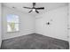 Well-lit bedroom features plush carpeting, a ceiling fan, and a window with blinds for natural light at 656 Pistoia Ln. # 304, Myrtle Beach, SC 29579