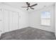 Bright bedroom with neutral carpet, a ceiling fan, window with blinds, and double door closet at 656 Pistoia Ln. # 304, Myrtle Beach, SC 29579