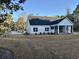Exterior view of a charming home featuring a screened-in porch and manicured lawn at 909 Grimes St., Georgetown, SC 29440