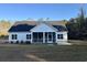 Exterior rear view of a single-Gathering home, showcasing a screened-in porch and well-maintained lawn at 909 Grimes St., Georgetown, SC 29440