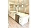 Bright kitchen with stainless steel dishwasher and white cabinets with black hardware at 909 Grimes St., Georgetown, SC 29440