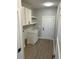 Laundry room features overhead cabinets, a quartz countertop and sink, and a utility closet at 909 Grimes St., Georgetown, SC 29440