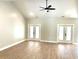 Open living room with hardwood floors, high ceilings, and white french doors at 909 Grimes St., Georgetown, SC 29440