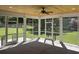 Cozy screened-in porch featuring a wood ceiling, ceiling fan, and beautiful backyard views at 909 Grimes St., Georgetown, SC 29440