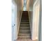 Carpeted staircase in a neutrally painted home with white doors and trim at 909 Grimes St., Georgetown, SC 29440
