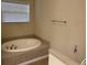 Bright bathroom with a soaking tub, tiled surround, and a large window at 1237 Spring Garden Rd., Conway, SC 29526