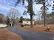 Quaint yellow house with a long driveway and well-maintained yard at 1237 Spring Garden Rd., Conway, SC 29526