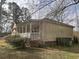 Side view of a cozy house with a screened porch and mature landscaping at 1237 Spring Garden Rd., Conway, SC 29526