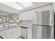 Modern kitchen with white cabinets, granite countertops, and stainless steel appliances at 23 Shadow Moss Pl. # 23, North Myrtle Beach, SC 29582