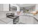 Modern kitchen with white cabinets, granite countertops, and stainless steel appliances at 23 Shadow Moss Pl. # 23, North Myrtle Beach, SC 29582