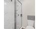 Large walk-in shower with marble tile and black accents at 23 Shadow Moss Pl. # 23, North Myrtle Beach, SC 29582