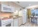 Well-equipped kitchen area features essential appliances and convenient dining space at 2301 S Ocean Blvd. # 1408, North Myrtle Beach, SC 29582