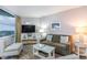 Cozy living room with stylish furnishings, lamps, and a window with natural light at 2301 S Ocean Blvd. # 1408, North Myrtle Beach, SC 29582