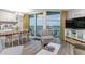 Bright living room featuring a comfortable sitting area, balcony access, and ocean views at 2301 S Ocean Blvd. # 1408, North Myrtle Beach, SC 29582