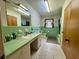 Mint green bathroom with tiled walls, bathtub, and vanity at 4575 Saints Delight Rd., Georgetown, SC 29440