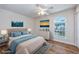 Virtually staged bedroom with wood floors and beige headboard at 6703 Jefferson Pl. # B2, Myrtle Beach, SC 29572
