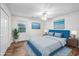Virtually staged bedroom with wood floors and blue headboard at 6703 Jefferson Pl. # B2, Myrtle Beach, SC 29572