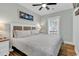 King-size bed in bright bedroom with wood floors and TV at 6001 - 1778 S Kings Hwy., Myrtle Beach, SC 29575