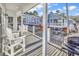 Spacious deck with white chairs and grill, offering views of neighboring homes at 6001 - 1778 S Kings Hwy., Myrtle Beach, SC 29575