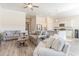 Open living room with neutral colors, hardwood floors, and a view of the kitchen at 6025 Mcclain Ct., Little River, SC 29566