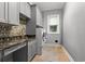 Laundry room with gray cabinets and granite countertop at 8030 Wacobee Dr., Myrtle Beach, SC 29579