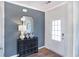 Stylish entryway featuring a black accent wall, decorative mirror, and elegant black dresser with decorative accents at 873 Agostino Dr., Myrtle Beach, SC 29579