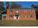 Charming red brick two-story home with black shutters and mature trees at 2110 4Th Ave., Conway, SC 29527