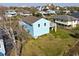 Back of a beach house showing a large deck and yard at 243 Calhoun Dr., Garden City Beach, SC 29576