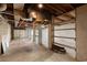 Unfinished basement garage with shelving and concrete floor at 243 Calhoun Dr., Garden City Beach, SC 29576