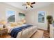 Bedroom with hardwood floors, white metal bed frame and beach themed art at 243 Calhoun Dr., Garden City Beach, SC 29576