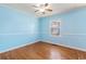Light blue bedroom with hardwood floors and ceiling fan at 243 Calhoun Dr., Garden City Beach, SC 29576