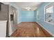 Light and airy dining area with hardwood floors and light blue walls at 243 Calhoun Dr., Garden City Beach, SC 29576