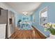 Kitchen dining area with hardwood floors and light blue walls at 243 Calhoun Dr., Garden City Beach, SC 29576