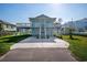 Two-story home with light blue siding, deck, and stairs at 243 Calhoun Dr., Garden City Beach, SC 29576