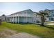 Elevated home with light blue siding, deck, and two-car garage at 243 Calhoun Dr., Garden City Beach, SC 29576