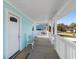Charming front porch with white railings and seating area at 243 Calhoun Dr., Garden City Beach, SC 29576