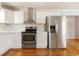 Modern kitchen features stainless steel appliances and white cabinets at 243 Calhoun Dr., Garden City Beach, SC 29576