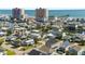 An aerial view showcasing a coastal neighborhood near the beach, featuring colorful homes and ocean views at 302A 32Nd Ave. N, North Myrtle Beach, SC 29582