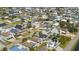 Aerial view showing a residential area with colorful beach homes and roads near a body of water at 302A 32Nd Ave. N, North Myrtle Beach, SC 29582