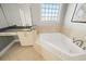 This bathroom features tile floors, a modern bathtub, a double vanity, and great lighting at 302A 32Nd Ave. N, North Myrtle Beach, SC 29582