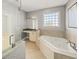 Primary bathroom features a double vanity, modern bathtub, and a patterned tile feature wall at 302A 32Nd Ave. N, North Myrtle Beach, SC 29582