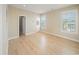 Bright bedroom with neutral wallpaper, a large window, and new light wood flooring at 302A 32Nd Ave. N, North Myrtle Beach, SC 29582