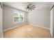 The bedroom is bright with a ceiling fan, hardwood floors, and natural light coming in from the window at 302A 32Nd Ave. N, North Myrtle Beach, SC 29582
