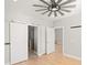 Bedroom features hardwood floors, ceiling fan, and doorway into the ensuite bathroom with a glass shower at 302A 32Nd Ave. N, North Myrtle Beach, SC 29582