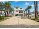Charming elevated beach home with a spacious driveway and lush palm trees at 302A 32Nd Ave. N, North Myrtle Beach, SC 29582