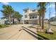 Inviting elevated beach home with a garage and a well-maintained driveway at 302A 32Nd Ave. N, North Myrtle Beach, SC 29582