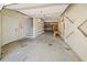 A clean, empty garage with shelving, a workbench, and a white door leading inside at 302A 32Nd Ave. N, North Myrtle Beach, SC 29582